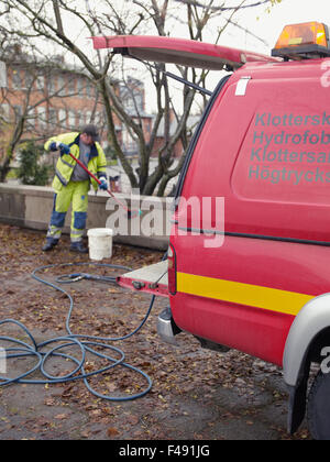 A man removing graffiti, Sweden. Stock Photo