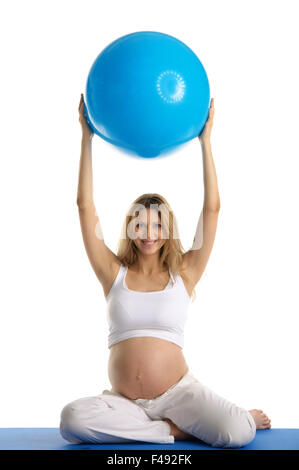Pregnant woman practicing yoga with ball Stock Photo