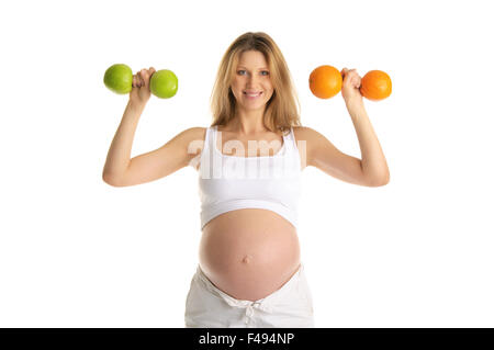 Pregnant woman involved in fitness dumbbells Stock Photo