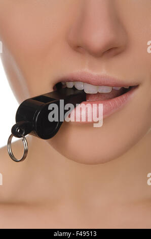 woman holding whistle in his mouth closeup Stock Photo