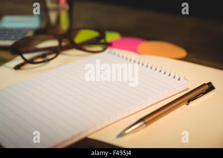 High angle view of notepad and pen on desk Stock Photo
