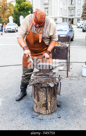 Blacksmith handles the horseshoe on the anvil Stock Photo