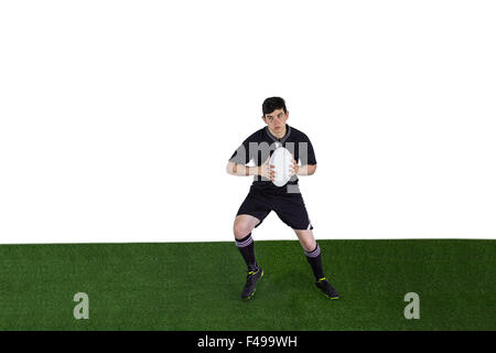 Rugby player running with the rugby ball Stock Photo