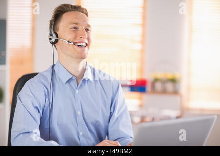 Casual businessman using headset on a call Stock Photo