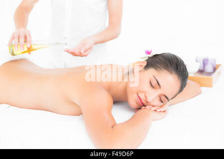 Beautiful brunette enjoying an oil massage Stock Photo