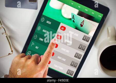 Composite image of man using tablet pc Stock Photo