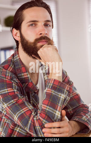 Hipster businessman thinking at his desk Stock Photo