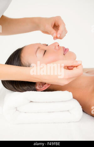 Hands threading beautiful womans face Stock Photo