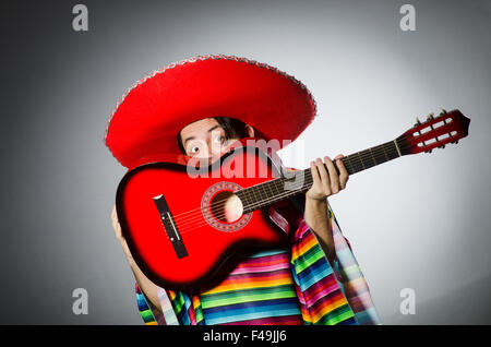 Man in red sombrero playing guitar Stock Photo