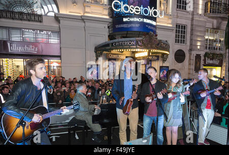 London, UK. 15th Oct, 2015.  American music legend Burt Bacharach, 87, accompanies the London cast of the hit musical Close to You, Bacharach Reimagined on a grand piano for a rendition of his hit song Raindrops Keep Falling on my Head in Piccadilly Circus. It is the musical's opening night as it transfers to the Criterion Theatre in London's West End. Credit:  theatrepix/Alamy Live News Stock Photo