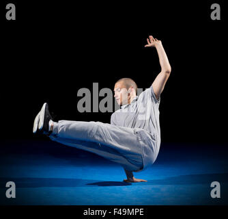 Breakdancer training on dark background Stock Photo