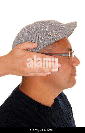 Woman cover the ear's of her man. Stock Photo
