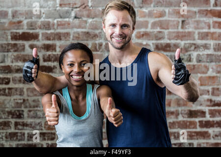 Fit smiling couple posing together Stock Photo
