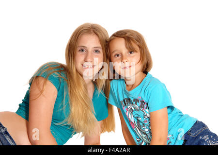 Two little sisters lying on the floor. Stock Photo