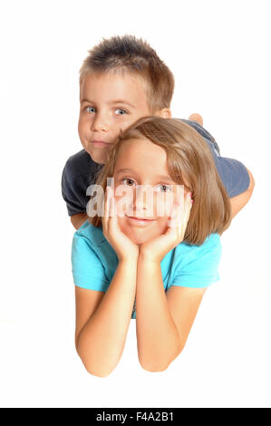 A sister and brother lying on the floor. Stock Photo