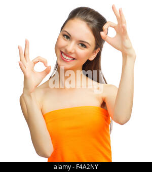 Young girl shows ok gesture isolated Stock Photo