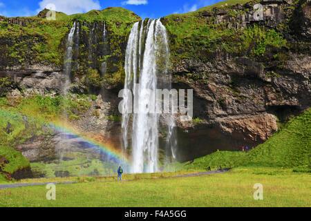 Large rainbow decorates a drop of water Stock Photo