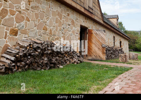 Seasoned firewood stacked next to wall - USA Stock Photo