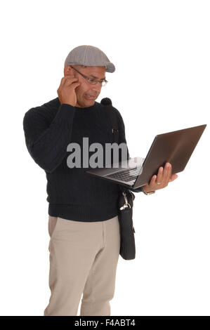 A Hispanic man working on his laptop. Stock Photo