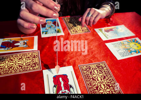 Cropped image of fortune teller using pendulum Stock Photo