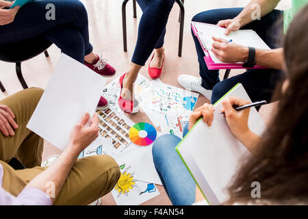 Students sitting in circle working together Stock Photo