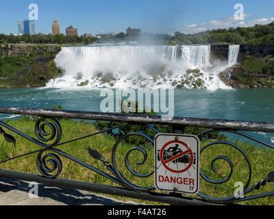 Danger sign on a metal fence facing the American Falls, one of the falls at Niagara Stock Photo