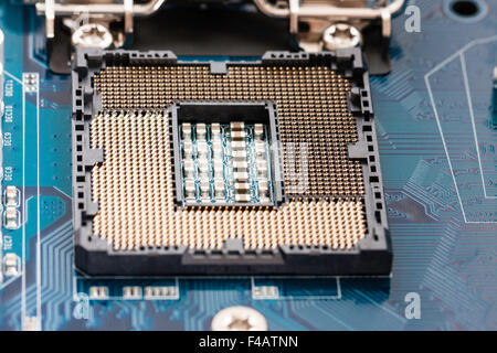 Motherboard of computer, with an empty Intel 1156 socket processor base, open showing the processor pin array before the processor is fitted. Stock Photo