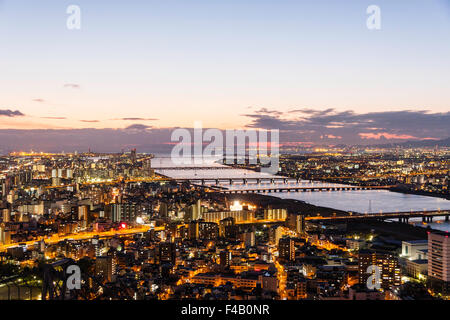 Japan, Osaka Bay area, view from Umeda Sky Building at dusk, blue hour. Yodogawa bridge and Yodo river with after sunset with mauve twilight sky Stock Photo