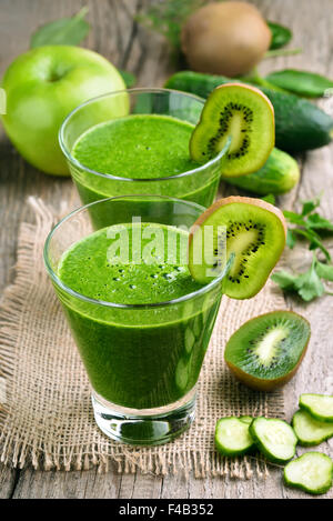 Kiwi and cucumber smoothie on rustic table Stock Photo