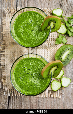 Smoothie with kiwi, cucumber, apple on rustic table, top view Stock Photo