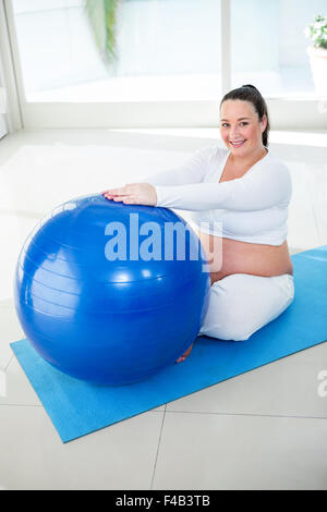 Pregnant woman exercising on ball Stock Photo