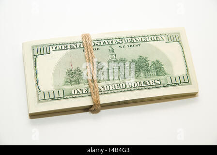 One pack of dollars tied up with rope on over white Stock Photo