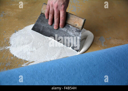 a floor fitters at work Stock Photo