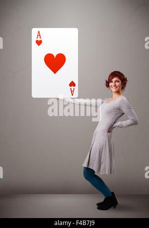 Beautiful woman holding red heart ace Stock Photo