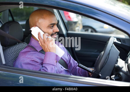 driver parked in a car pari to make a phone call Stock Photo