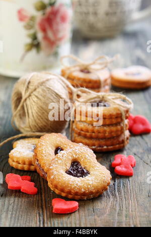 Red hearts marzipan and Linzer Cookie. Stock Photo