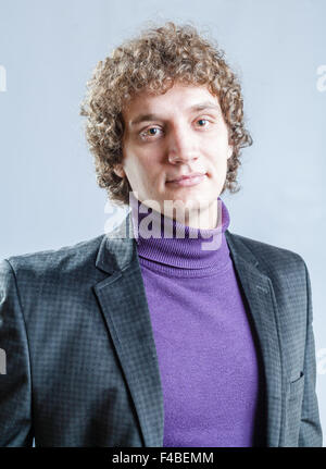 portrait of a young guy with curly hair Stock Photo