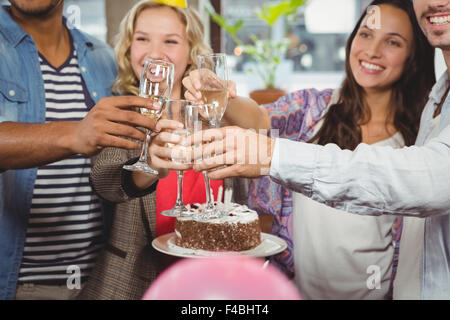 Business people toasting over birthday cake Stock Photo