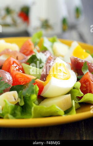 Salad with anchovies, tomatoes and eggs. Stock Photo