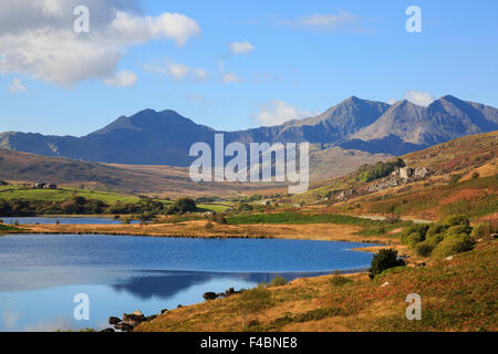 View to Mount Snowdon horseshoe mountains across Llynnau Mymbyr lakes in Snowdonia National Park (Eryri) in autumn. Capel Curig North Wales UK Britain Stock Photo