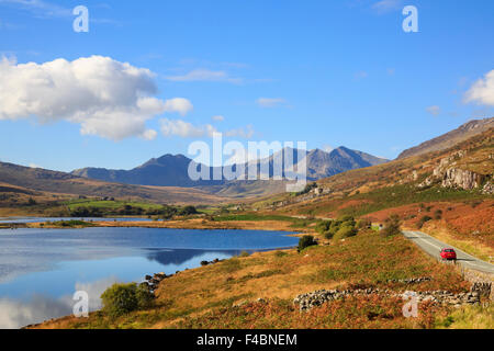 A4086 road beside Llynnau Mymbyr lakes with view to Mount Snowdon horseshoe in Snowdonia National Park (Eryri) in autumn. North Wales UK Stock Photo