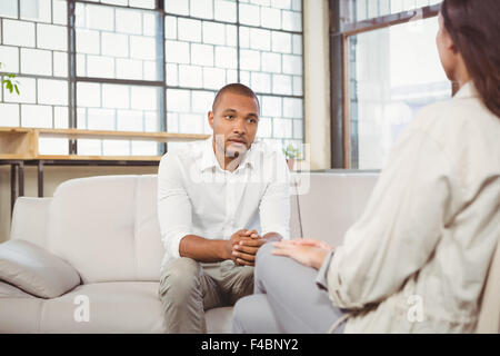 Depressed patient interacting with counselor at clinic Stock Photo