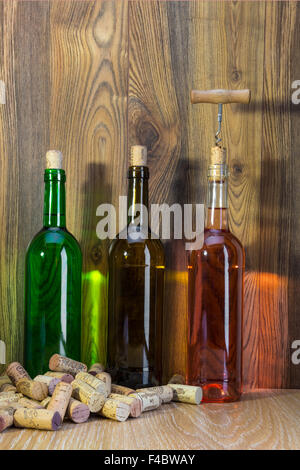 bottle of wine and corks on the background of dark wood Stock Photo