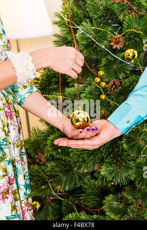 female giving christmas ball to male Stock Photo