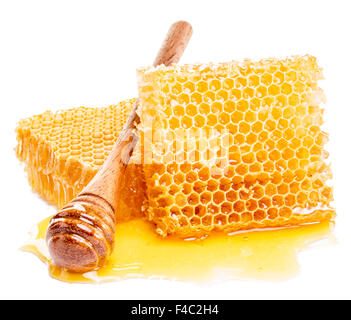 Honeycomb and honey drizzler on a white background.  High-quality picture. Stock Photo