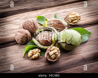 Walnut and walnut kernel on the wooden table. Stock Photo