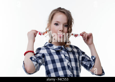 Funny little girl pulls herself for earrings Stock Photo