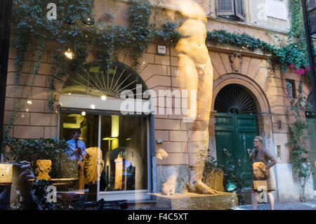 Via Margutta reflected on an Antiques shop window display. Rome, Italy Stock Photo