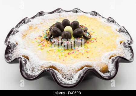 Easter cake with ricotta and chocolate decorated with chocolate eggs and powdered sugar Stock Photo