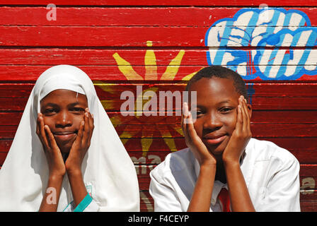 Tanzania, Mwanza, Muslim and Christian students hugging as friends Stock Photo